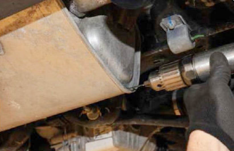 Drill a 1/8-inch weep hole in the lower rear of the muffler.