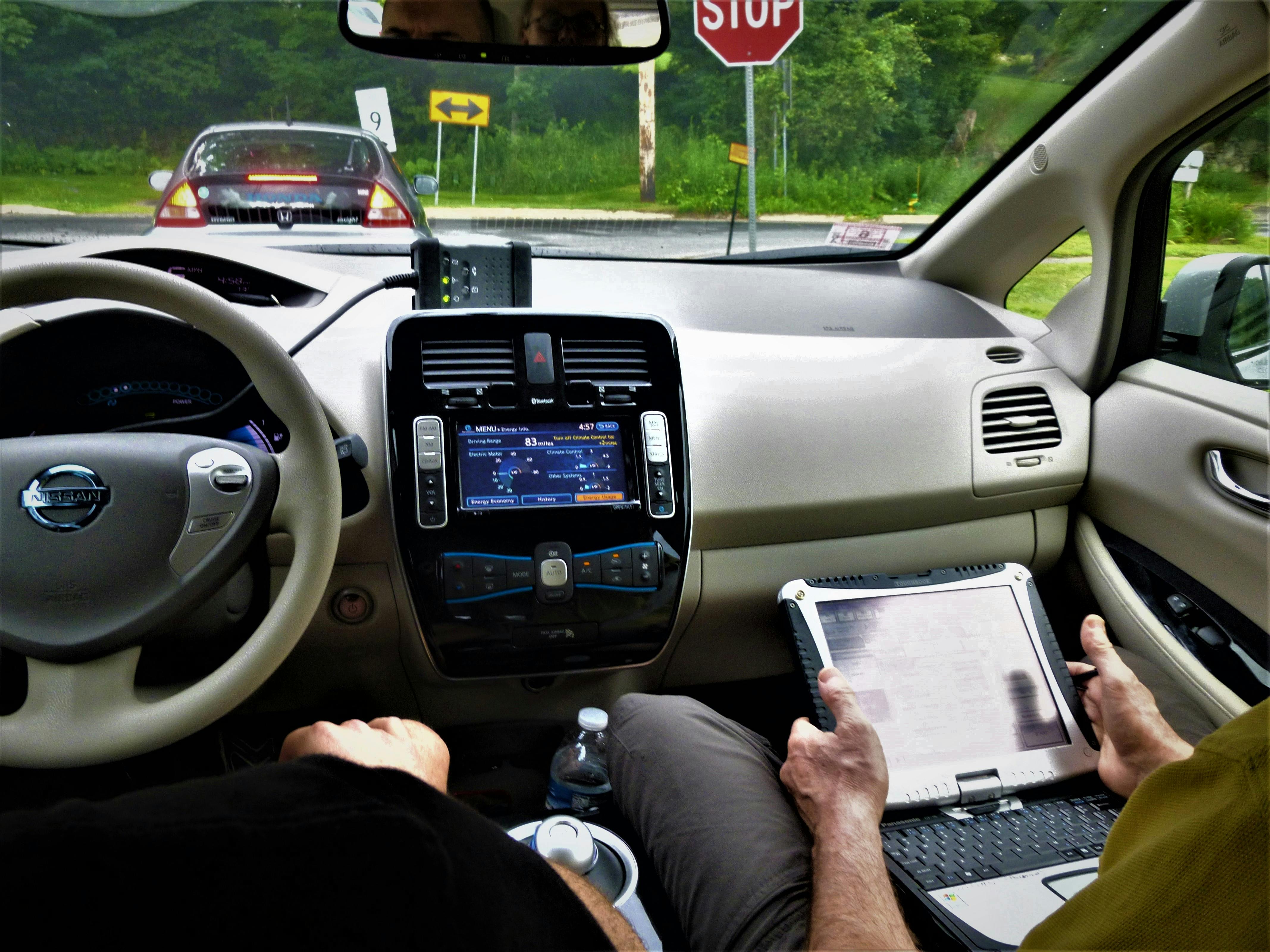 Two technicians studying scan data on a road test.
