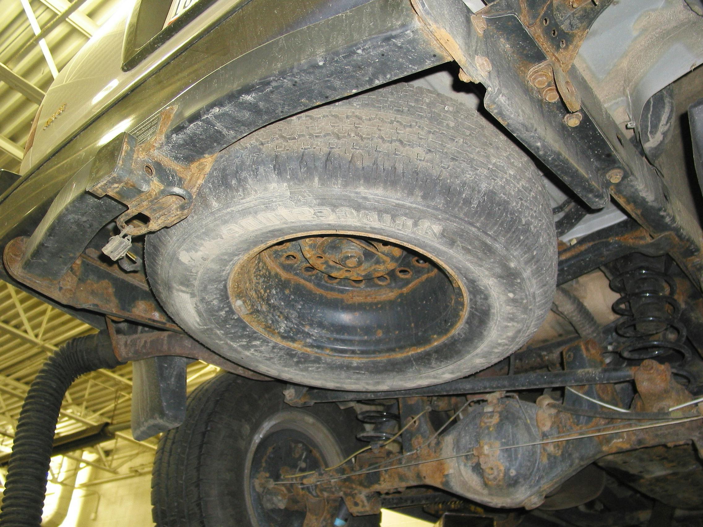 Banging/knocking noises can be caused by loose spare tire/wheel assemblies. Don&rsquo;t forget to check this, whether under the vehicle or in the trunk. Such noises may be mis-interpreted as a suspension issue.