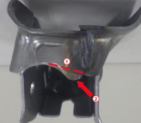 If necessary, trim the support bracket to provide needed clearance. Do not remove more than 5mm of material. The example shown here shows the cut line (1) and area to provide clearance (2).