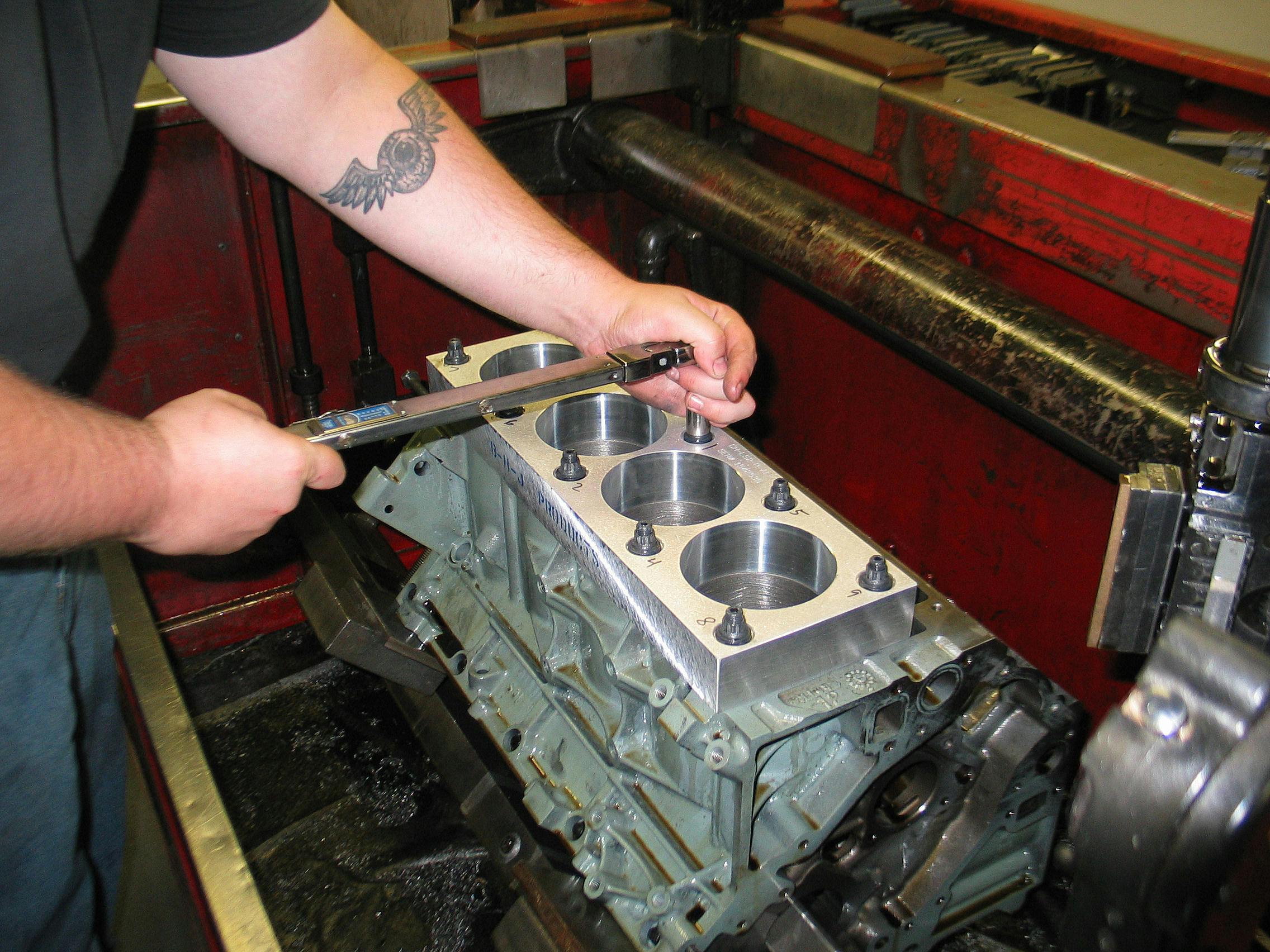 Prior to cylinder honing, the deck plate is torqued to specification to simulate the stress placed on the block when cylinder heads are installed.
