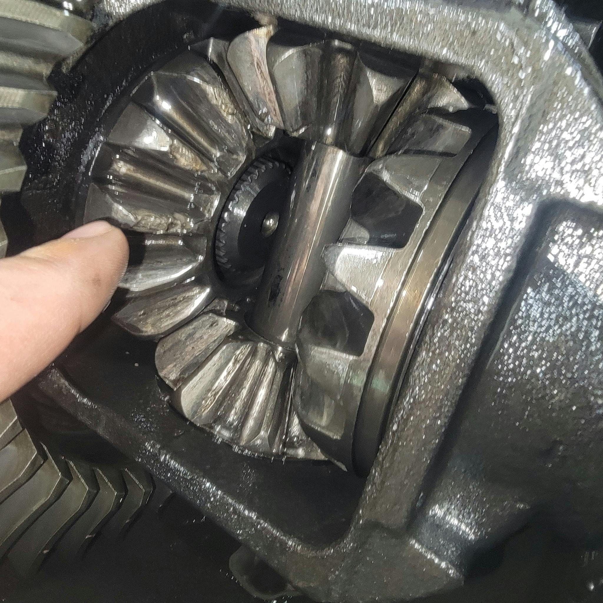 Fig. 5 - Failed differential internal kit. Note the chipped teeth on the side gear is a clear indicator of ingesting debris. Failure to fully clean the housing will cause a repeat failure.