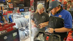 Cornwell Quality Tools Distributor Frank Orphey assisting a customer on his tool truck Cornwell Quality Tools Distributor Frank Orphey assisting a customer on his tool truck