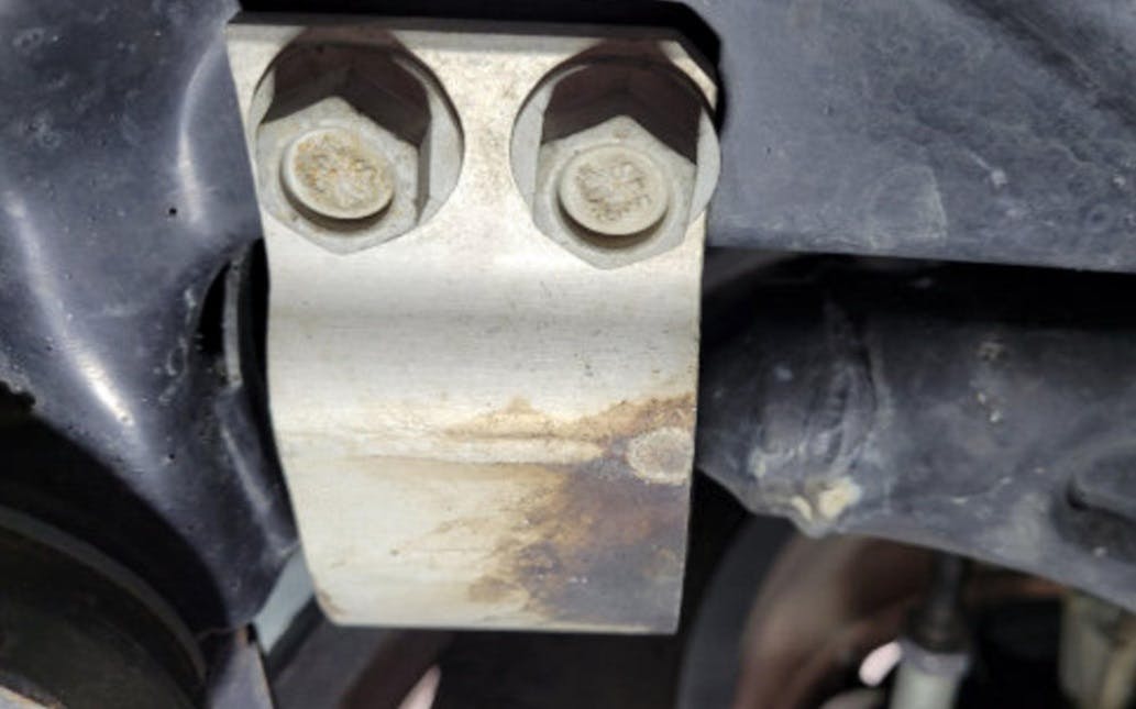 A leaking hydraulic rear bushing on a front control arm can result in a continued steering shake.