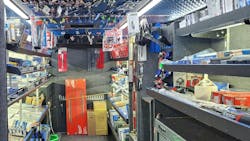 the interior of a tool truck with gray carpeting on the walls with grey metal shelves full of tools and boxes on either side of the truck the interior of a tool truck with gray carpeting on the walls with grey metal shelves full of tools and boxes on either side of the truck