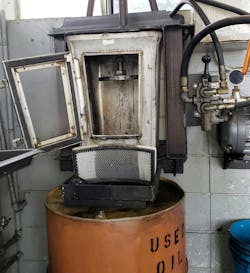 Example of an oil filter crusher. The used engine oil filter is placed in the unit and a hydraulic ram extends downward and crushes the filter. In this example, the oil that is squeezed out runs through an air filter before being drained into the used oil barrel. Example of an oil filter crusher. The used engine oil filter is placed in the unit and a hydraulic ram extends downward and crushes the filter. In this example, the oil that is squeezed out runs through an air filter before being drained into the used oil barrel.