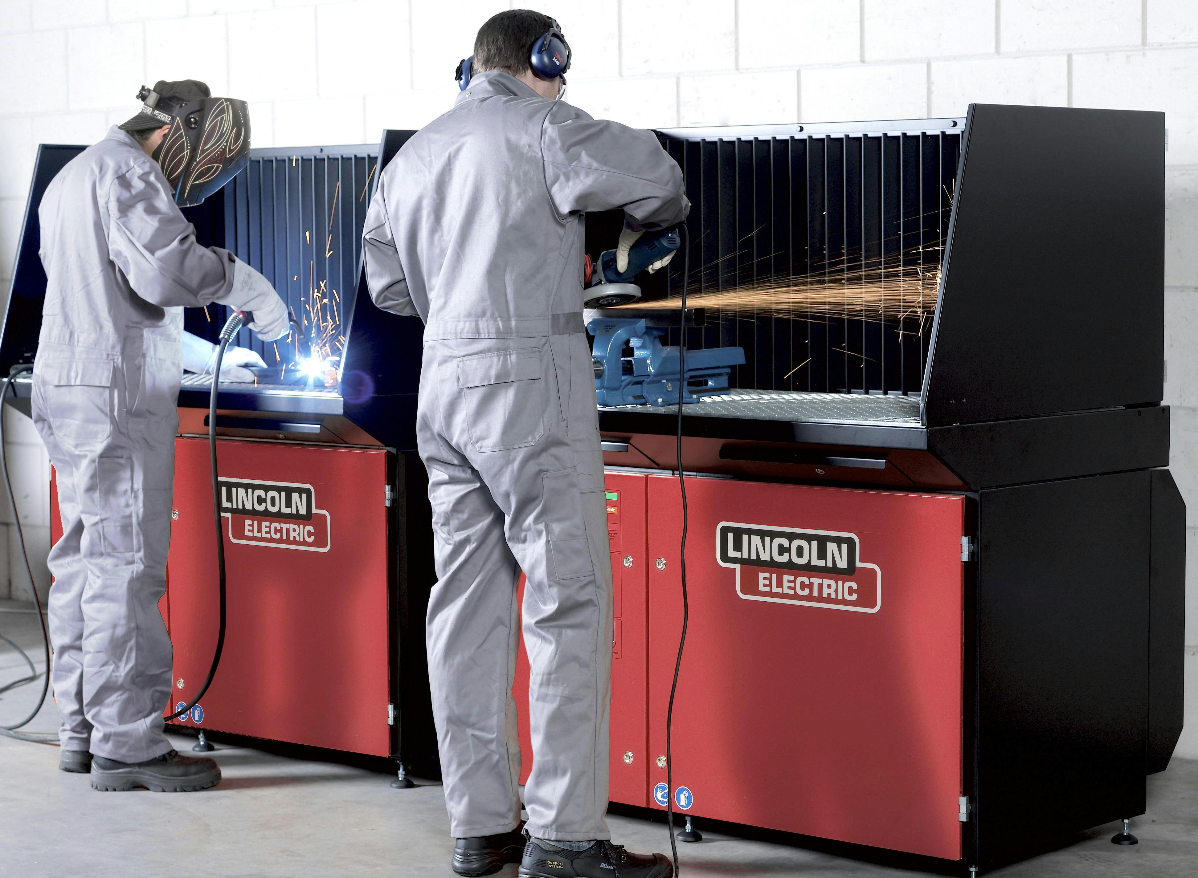 When welding or grinding, protective apparel and safety shields protect the operator and others nearby. This downdraft booth system is an example.