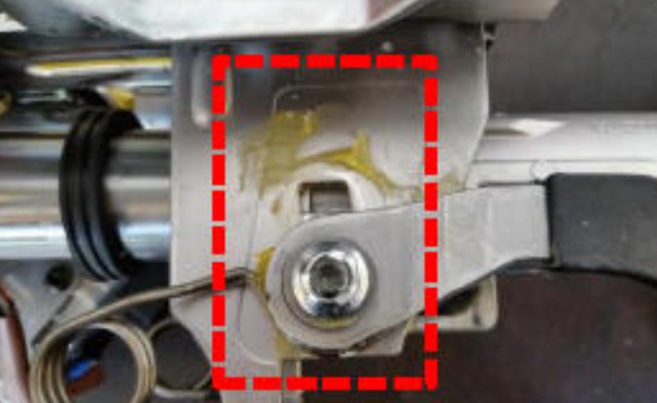 Example of liquified excess grease dripping from the steering column tilt mechanism.