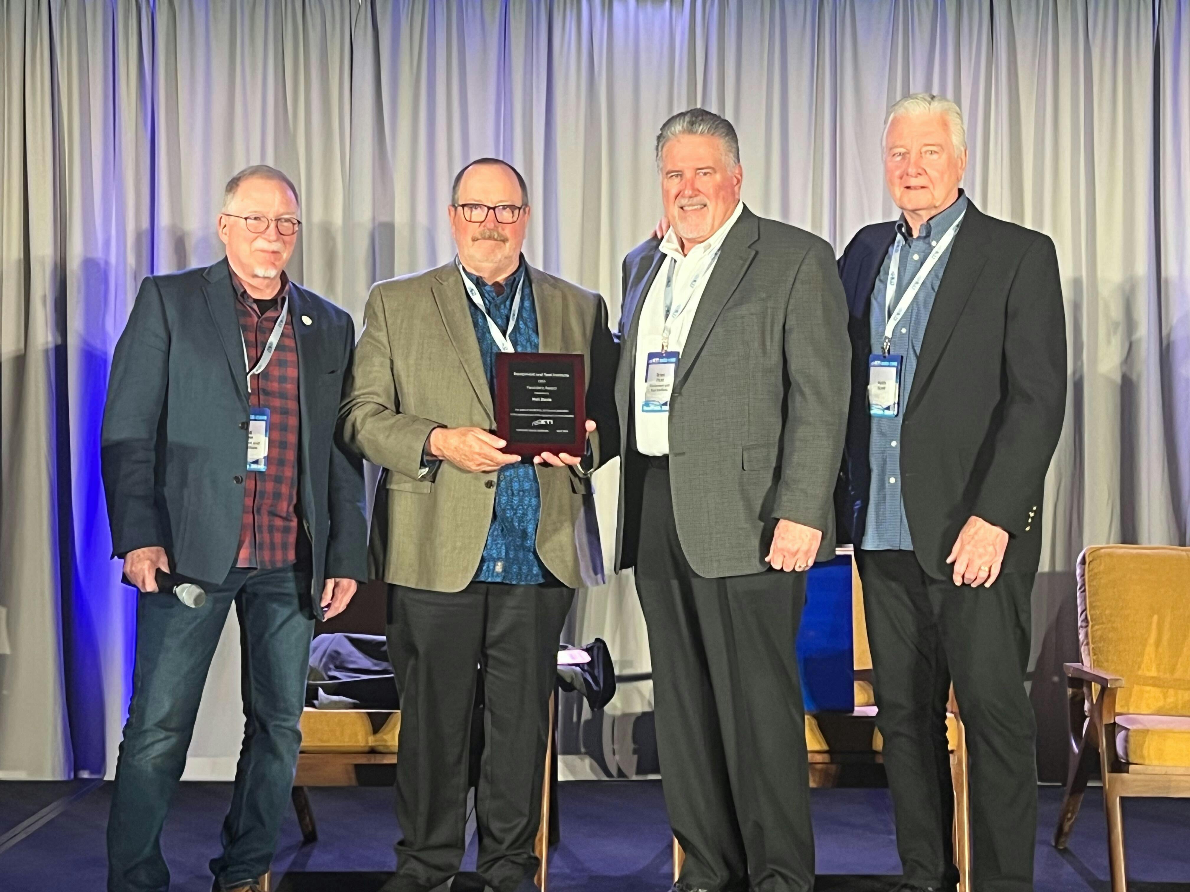 Neil Davis (center left) is presented with the 19th ETI Founder's Award by Greg Potter (far left), Brian Plott (center right), and Keith Kreft (far right).