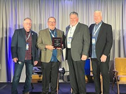 Neil Davis (center left) is presented with the 19th ETI Founder's Award by Greg Potter (far left), Brian Plott (center right), and Keith Kreft (far right). Neil Davis (center left) is presented with the 19th ETI Founder's Award by Greg Potter (far left), Brian Plott (center right), and Keith Kreft (far right).