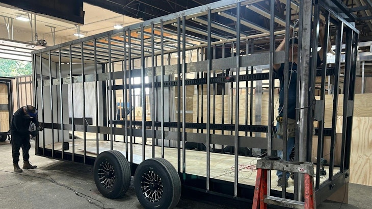 Custom tool trailer frame under construction, showing recessed e-track welded to wall posts.