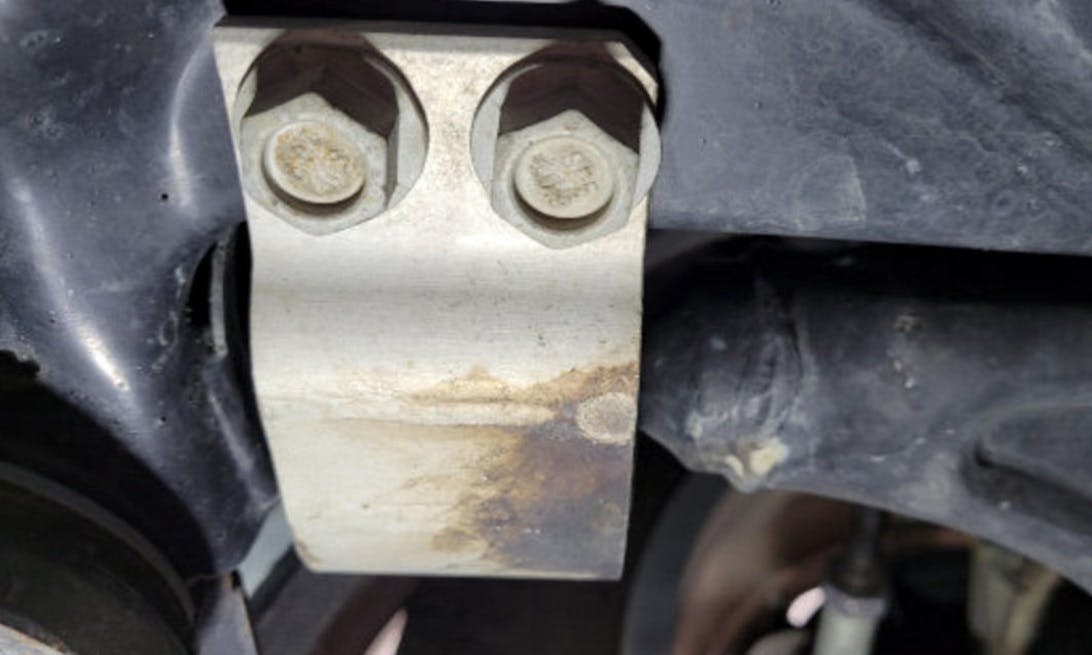 Inspect the front control arm rear bushing for oil leakage.