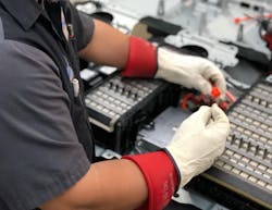 Figure 7 — Wearing insulated gloves while working on an EV helps keep technicians safe. Figure 7 — Wearing insulated gloves while working on an EV helps keep technicians safe.