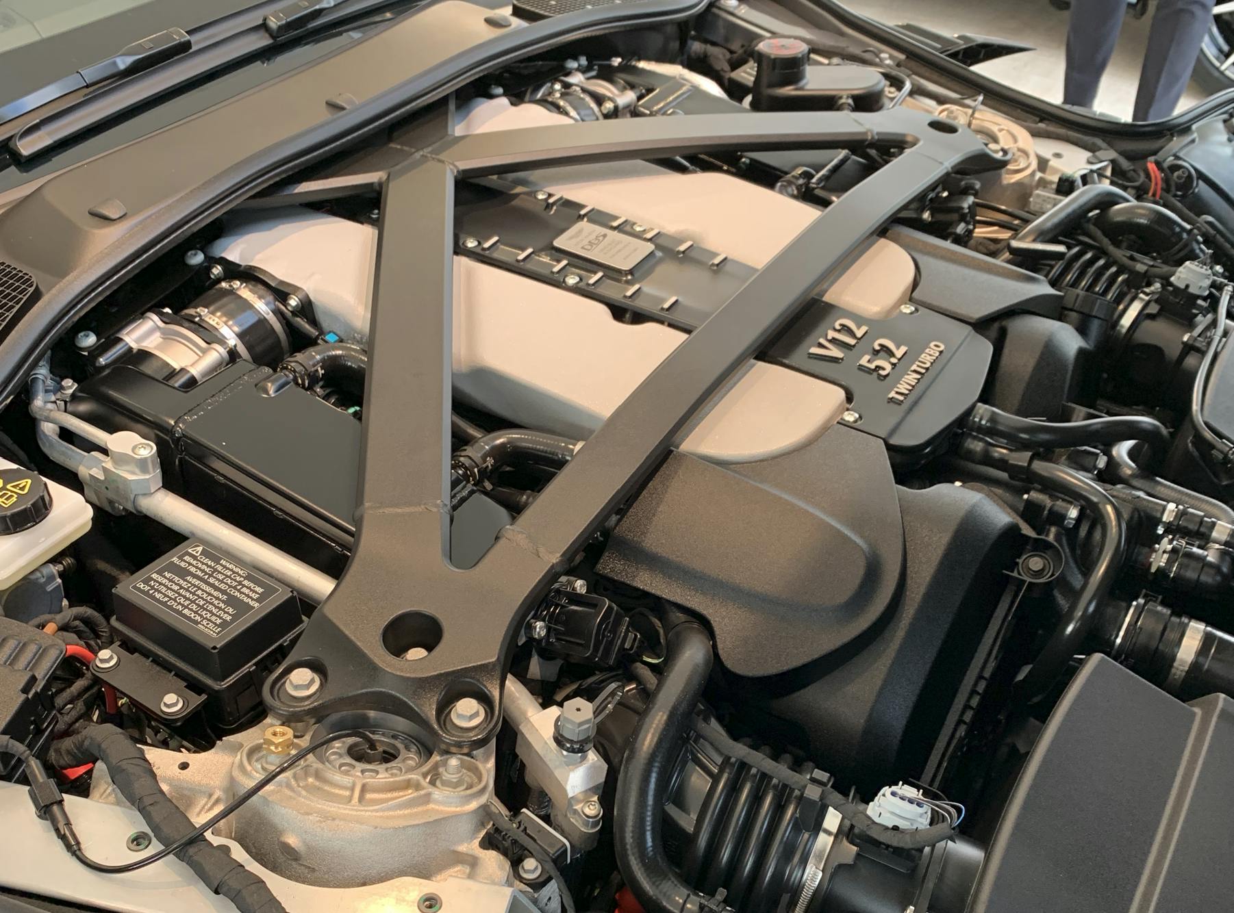Fig. 1: It&rsquo;s engine bay configurations like this Aston Martin V12 that make the tried-and-true tests like the compression test (with a mechanical gauge) a tough pill to swallow. These tests, intended to be easy, could take hours to perform.