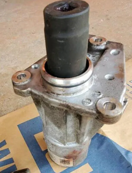 Using bearing tool J-06133-A, press the bearing from the housing. Position the new bearing to the housing. Using bearing tool J-41736, press the bearing into the housing until seated. Install a new ring.