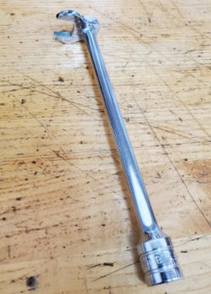 A 13mm crow's foot wrench on a long extension is required.
