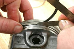 Checking ring sideplay with a feeler gauge. Refer to specs, but sideplay is generally 0.001 to 0.006-inch. If too tight, the ring can drag and stick in the groove. Too wide and the ring can deflect excessively. Checking ring sideplay with a feeler gauge. Refer to specs, but sideplay is generally 0.001 to 0.006-inch. If too tight, the ring can drag and stick in the groove. Too wide and the ring can deflect excessively.