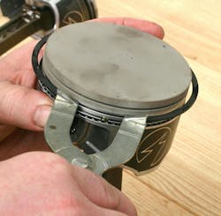 Use a ring expender tool to install the second ring, followed by the top ring. Avoid twisting rings. Expand just enough to allow installation. Use a ring expender tool to install the second ring, followed by the top ring. Avoid twisting rings. Expand just enough to allow installation.