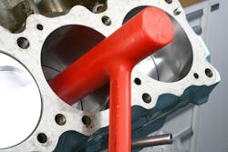 In some cases, you may be able to push the piston down to mate the rod big end saddle to the rod journal, it’s common to need to “nudge” the piston down. Gently tap the piston dome using a clean plastic tool, such as a piston driver tool shown here which features a long hammer head. In some cases, you may be able to push the piston down to mate the rod big end saddle to the rod journal, it’s common to need to “nudge” the piston down. Gently tap the piston dome using a clean plastic tool, such as a piston driver tool shown here which features a long hammer head.