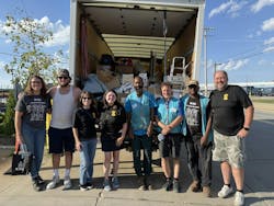 a group of eight people from Sonnhalter and Habitat for Humanity smile in front of a donations truck a group of eight people from Sonnhalter and Habitat for Humanity smile in front of a donations truck