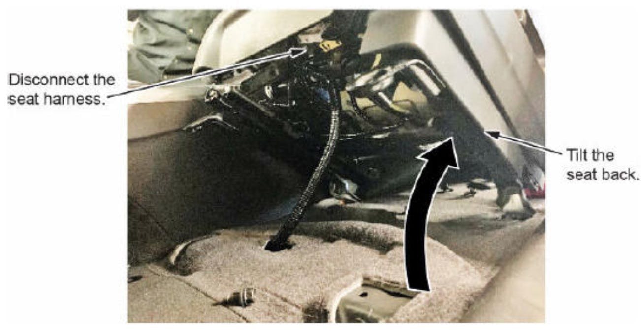 Tilt the seat back and disconnect the harness. Tilt the seat back and disconnect the harness.