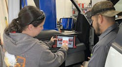 Mac distributor Maria Lee demonstrating a scan tool to a customer Mac distributor Maria Lee demonstrating a scan tool to a customer