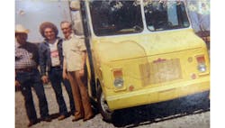 Danny Stratton (middle), his father, Harlan Stratton (left), and his first customer, Bruce Stratton (right), on April 20, 1980. Danny Stratton (middle), his father, Harlan Stratton (left), and his first customer, Bruce Stratton (right), on April 20, 1980.