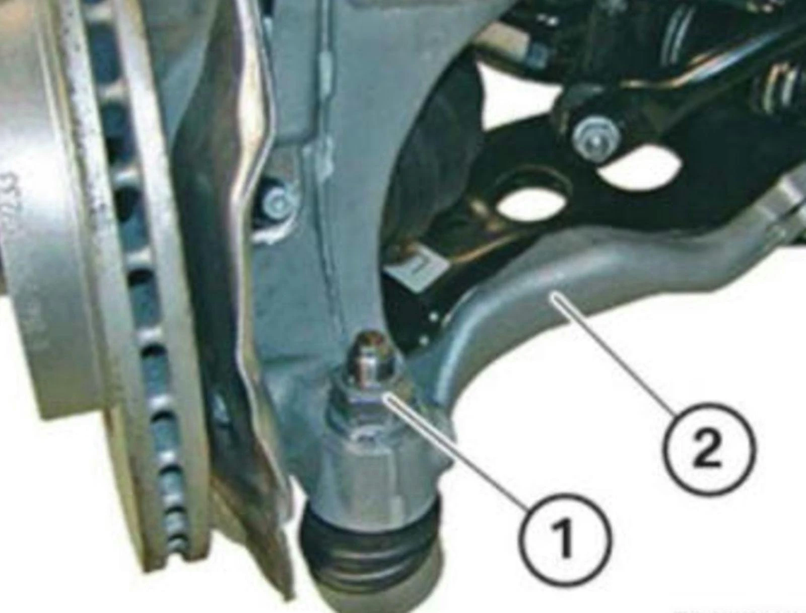 Remove the nut (1) and tie rod (2). Do not re-use the nut.