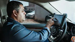 Automotive technician using a scan tool Automotive technician using a scan tool