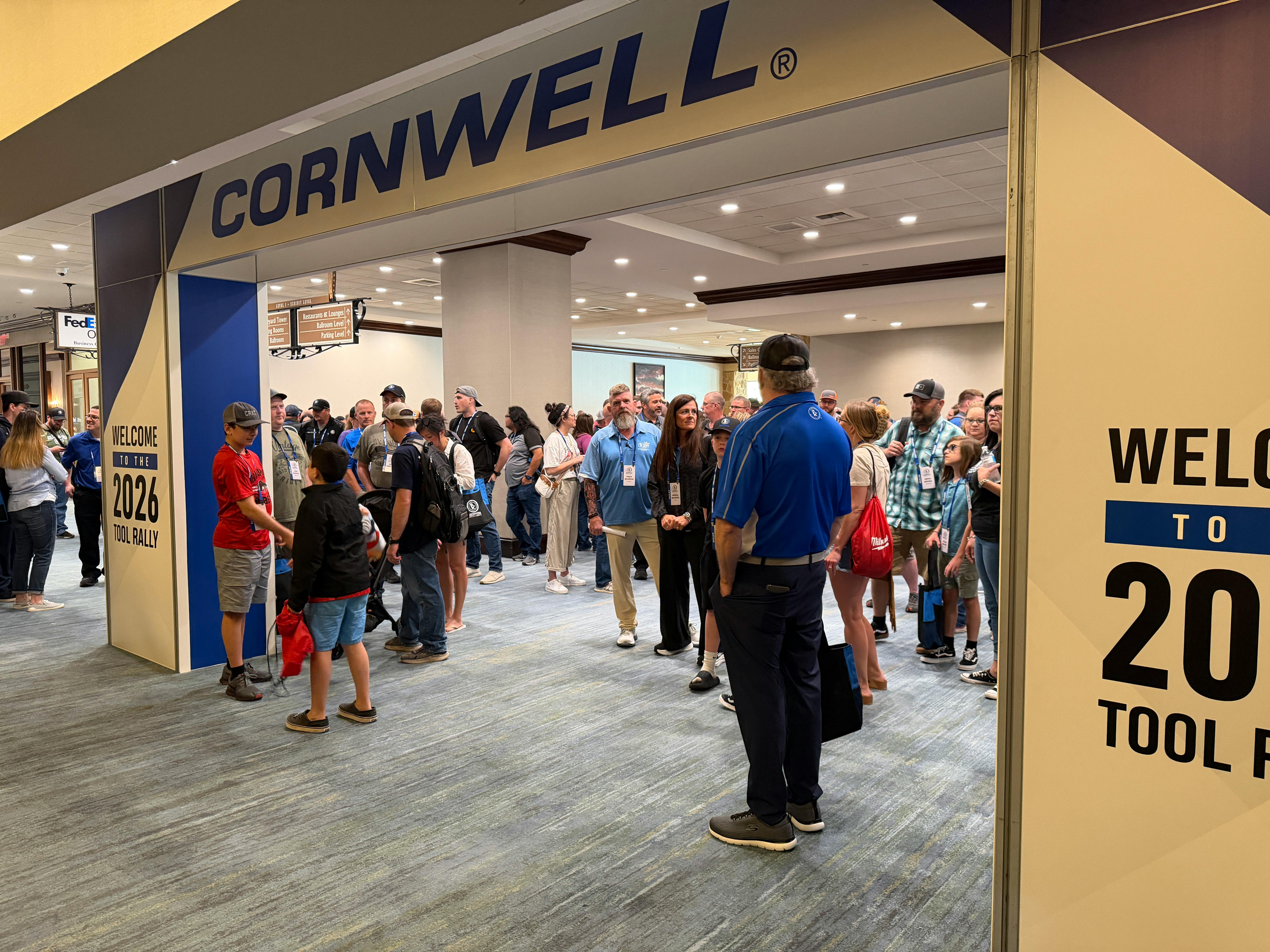 Crowds line up at the entrance to the Cornwell Quality Tools National Rally, marking the start of the event as distributors and attendees make their way inside.