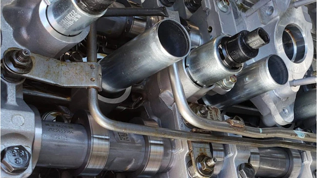 This Ford 5.0L V8 uses variable displacement. Looking closely, the zero-lash springs can be seen on the cam followers; they maintain contact when the rocker freewheels and the cylinder is deactivated.