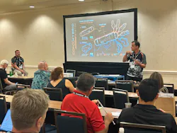 An SP Tools representative demonstrates the Con-X Hybrid System during the company’s training session at the MEDCO Customer Show, highlighting its interchangeable heads and cordless and pneumatic power options.