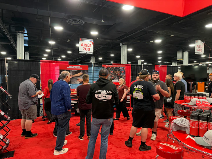 Attendees gather in the Milwaukee Tool booth at the MEDCO customer show for hands on tool demonstrations.