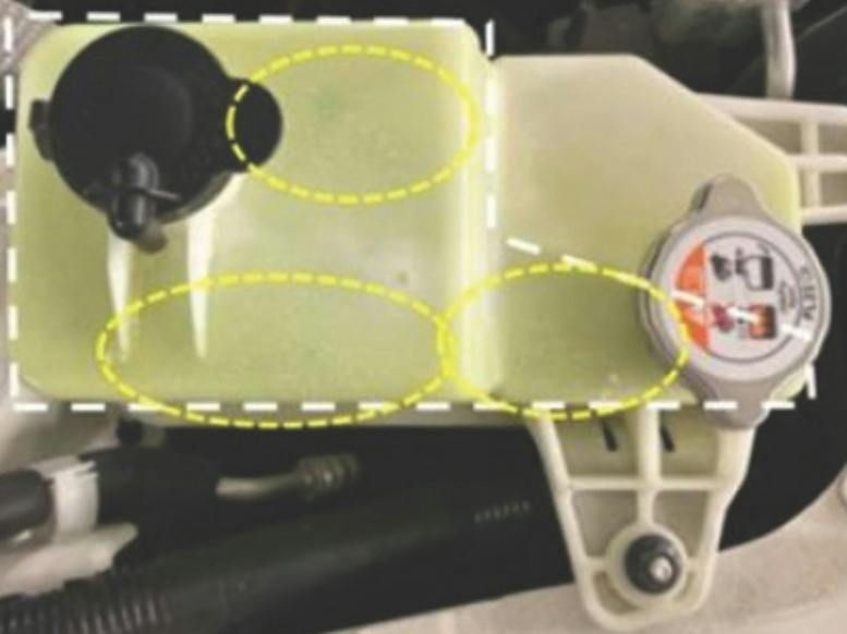 Example of coolant reserve tank leak areas (see circled in yellow).