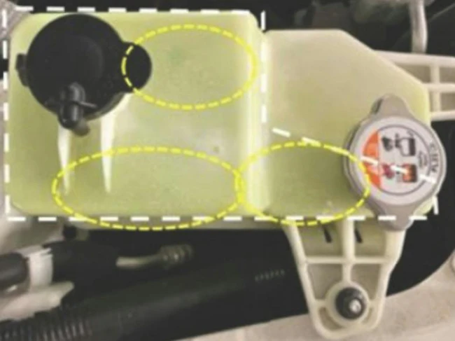 Example of coolant reserve tank leak areas (see circled in yellow).